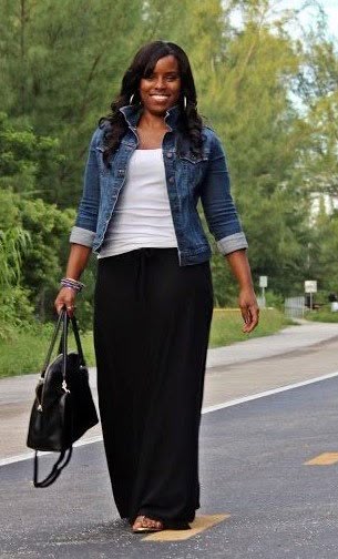 Casual outfit idea for women over 40 featuring denim jacket, white tank top, black maxi skirt, black handbag, and sandals for a relaxed everyday look.