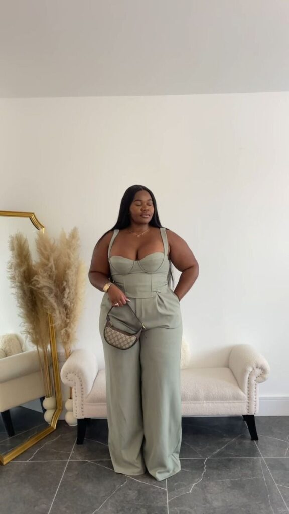 Elegant outfit idea for women over 40 featuring sage green structured bustier top, high-waisted wide-leg trousers, designer mini handbag, gold jewelry, and sleek hairstyle for a sophisticated chic look.